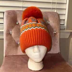 NWOT hat with extra large pompom in orange. OSFA
